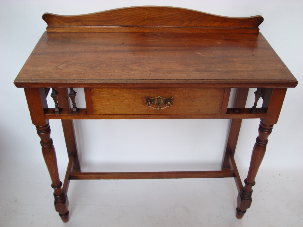 A late Victorian James Shoolbred & Co walnut writing table,