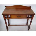 A late Victorian James Shoolbred & Co walnut writing table,