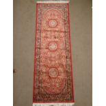 A Kashan stlye red ground runner.
210 x 70cm.