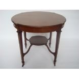 An Edwardian mahogany circular low table, on square tapering legs united by a platform stretcher,