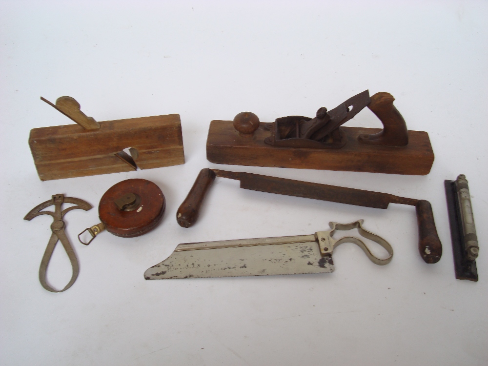 A small collection of woodworking tools to include planes, a J Rabone & Sons spirit level,