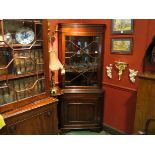A 19th Century mahogany full height corner cabinet with astragal glazed top over enclosed cupboard