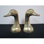 A pair of brass book ends in the form of duck heads