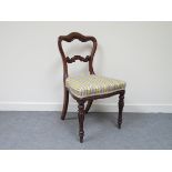 A Victorian rosewood shaped balloon back dining chair, striped upholstery, serpentine front on