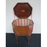 A 19th Century mahogany octagonal sewing box with lined interior over square tapering legs