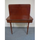 A 19th Century mahogany card table the hinged top with reeded edge over ring turned legs