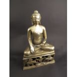 An Indian brass figure of seated deity, 38cm tall