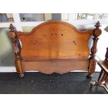 A flame mahogany double headboard with fluted rails, carved decoration