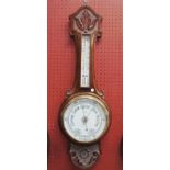 A Kendal and Dent London aneroid pendant barometer with long thermometer box and carved detail