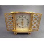 A Jaeger Le Coultre brass desk alarm clock with pierced gilt sliding doors