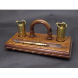 A trench art desk stand with twin 1914-18 dated shell inkwells and bullet fountain pen