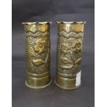 A pair of WWI trench art brass 18pr shells with hammered and foliate design