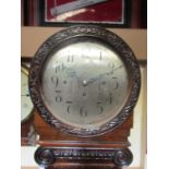 An Edwardian flame mahogany longcase clock by Maple of London, with round 12" silvered convex dial,