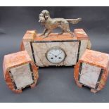 An Art Deco marble clock garniture surmounted by figure of a dog and pheasant