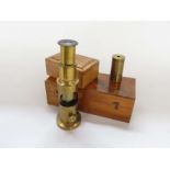 An early 20th Century brass pocket microscope together with a compact monocular field microscope of