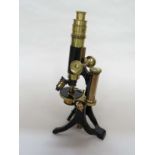 A late 19th Century/early 20th Century brass and black lacquered monocular microscope, telescopic,