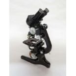 A 1950's Watson & Sons Ltd Bactil binocular microscope with 10x, 20x and 6x eye pieces,