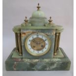 An onyx mantel clock of architectural form, Arabic dial with brass columns and finials,