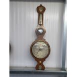 A Victorian five dial wheel barometer in mahogany and inlaid case with silvered dials