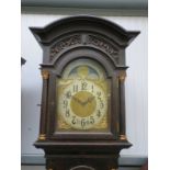 An Edwardian oak longcase clock, Arabic chapter ring with moon phase,