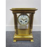 A 19th century brass cased four glass mantel clock with bevelled panels,