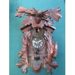 An early to mid 20th Black Forest cuckoo clock with carved decoration