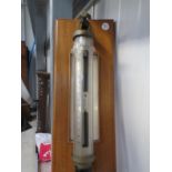 An early mid 20th Century marine tube barometer with silvered gauge and vernier,