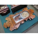 An early 20th Century American oak cased ginger bread wall clock with carved case, Roman dial,