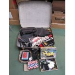 A suitcase of Scalextric track, transformers,