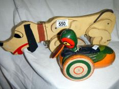 Two pull-along wooden toys of dog and du