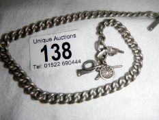 A silver military chain with cannon, gun and bugle
 
Condition
This weighs 36gms