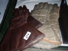 A pair of leather gauntlets and one othe