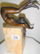 A bronze of a nude contortionist lady