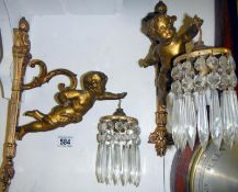 Two wall mounted cherub lights with drop