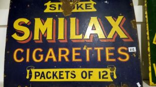 An Enamel sign - 'Smoke Smilax Cigarettes' (approx. 29 x 20 1/2" / 73.5 x 52cm