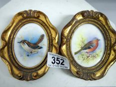 A pair of painted bird miniatures on por