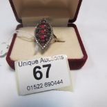 A silver dress ring with red and white s