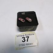 A pair of ruby and diamond gold earrings