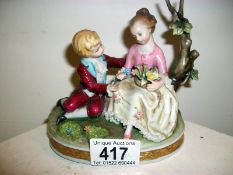 A Capodimonte figure of boy and girl wit