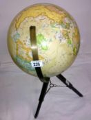 A table globe on wood and brass stand