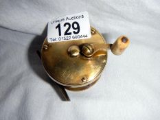 An old brass fishing reel