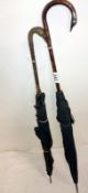 Two umbrellas with swan neck handles, on