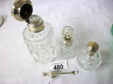 A quantity of Silver topped / collared bottles and a silver scent spoon