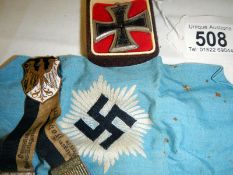 Three items of German military memorabilia consisting of a blue armband with Nazis Swastika, replica