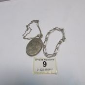 A silver locket on chain and a silver br