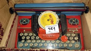 A toy tinplate Mettype Junior typewriter