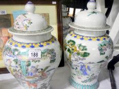 A pair of large Chinese lidded urns