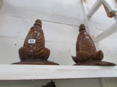 A pair of carved wood wall brackets