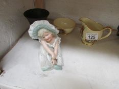 An Edwardian piano baby, a Wedgwood black vase and Newark cross sugar and creamer