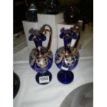 A pair of Bristol blue gilded glass urn vases